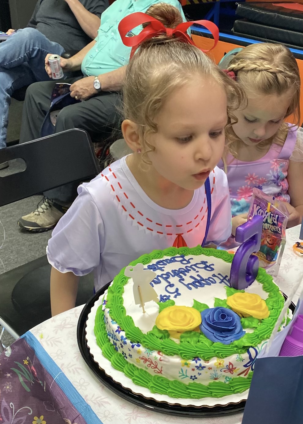 Child blowing out birthday candles